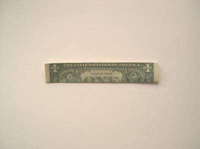 1 Dollar Bill Folded In Half With Black Background